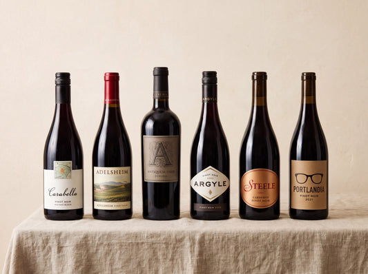 The Chillable Reds Case — six Pinot Noirs on a linen table